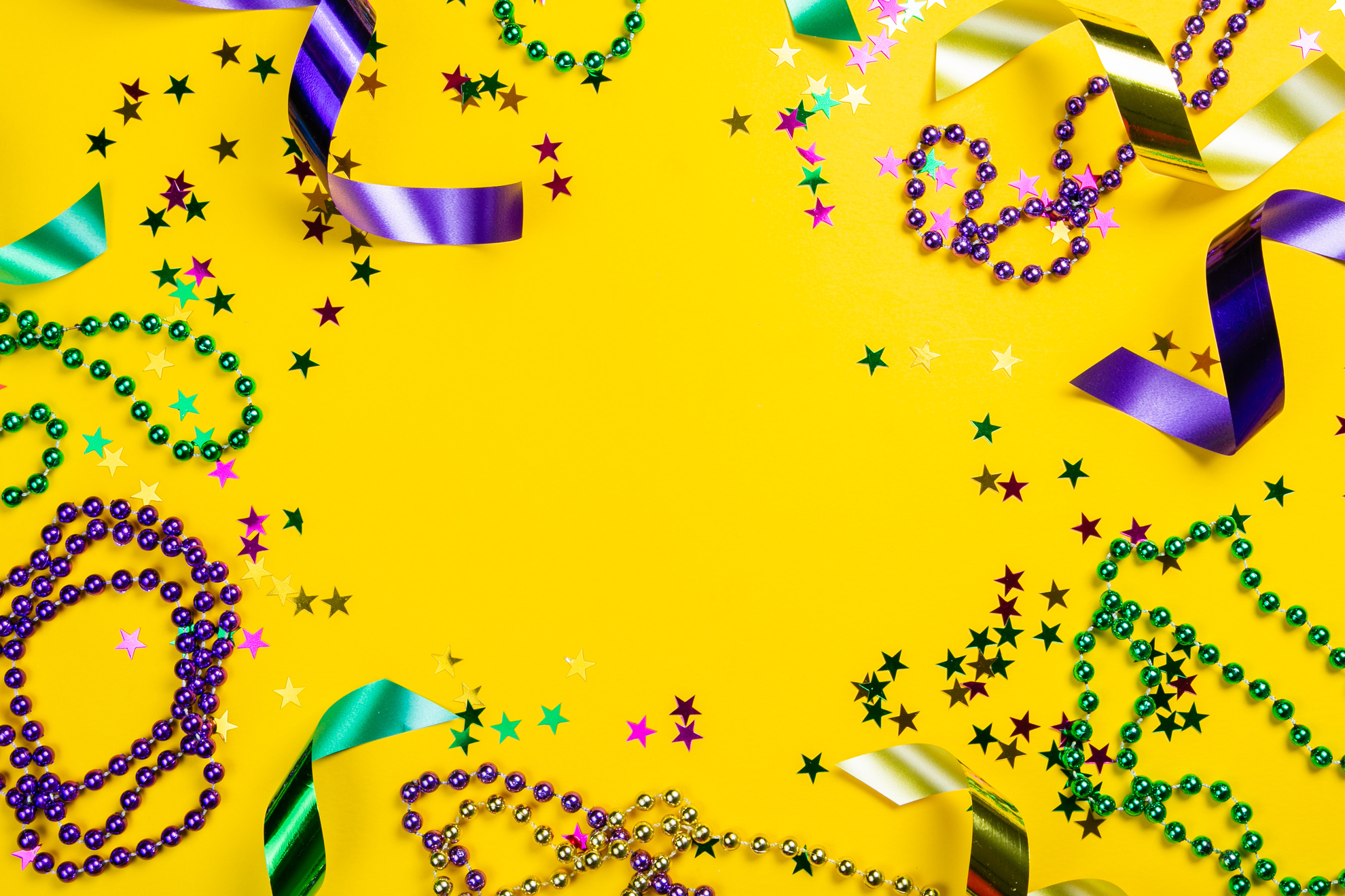 Mardi Gras Carnival Concept - Beads on Yellow Background