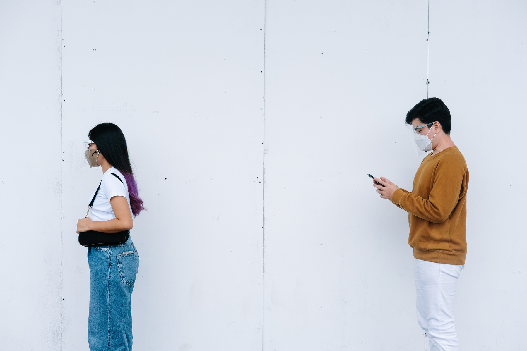 Man and Woman in Mask Practicing Social Distancing